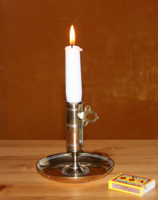 Candle: Wick embedded in solid flammable substance