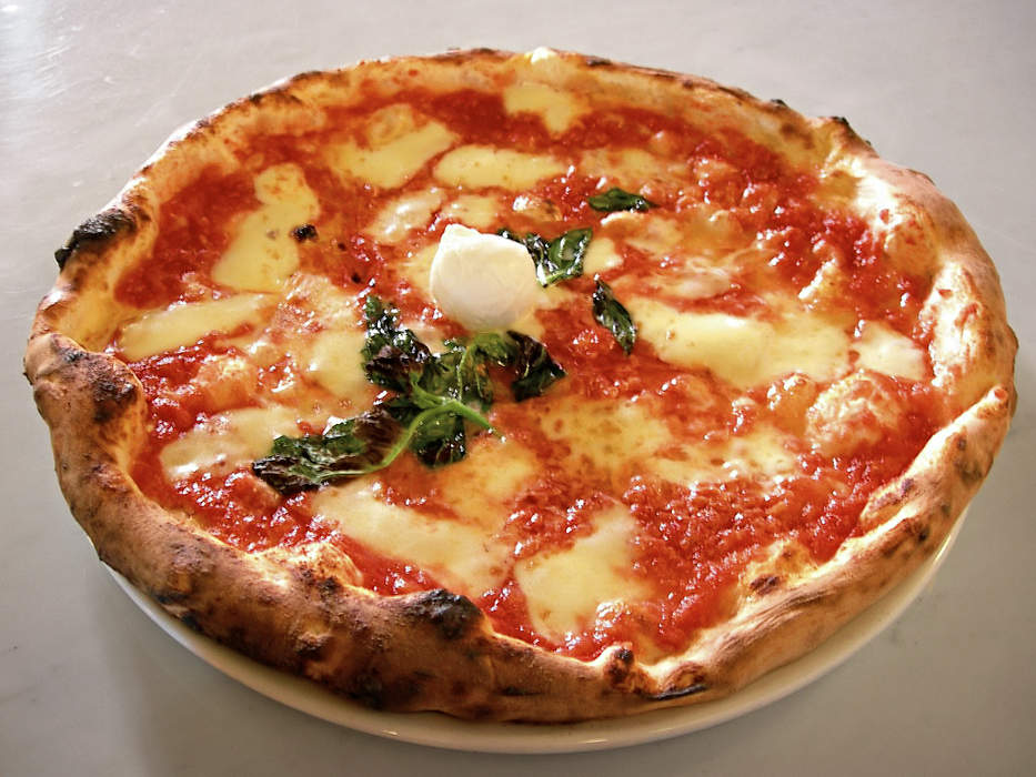 Pizza: Italian dish with a flat dough-based base and toppings